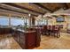 Gourmet kitchen with dark wood cabinets, granite countertops, stainless steel appliances, and a large island with seating at 1123 Christian Rd, Henderson, NV 89002