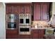 Built-in stainless steel Viking microwave, oven, and warming drawer appliances in a custom kitchen at 1123 Christian Rd, Henderson, NV 89002