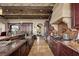 Spacious kitchen with stone floors, long island, modern appliances, and open layout into the dining area at 1123 Christian Rd, Henderson, NV 89002