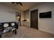 Cozy living room features carpeted floors and a black leather sofa at 1123 Christian Rd, Henderson, NV 89002