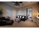 Elegant living room featuring a leather sofa set, stylish ceiling fan, and an open doorway at 1123 Christian Rd, Henderson, NV 89002