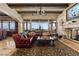 Spacious living room with leather seating, large windows offering spectacular views, and a stone fireplace at 1123 Christian Rd, Henderson, NV 89002