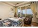 Bright main bedroom with hardwood floors, sitting area, large windows, and hillside view at 1123 Christian Rd, Henderson, NV 89002