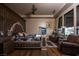 Stately main bedroom with dark wood floors, sitting area, and a TV that raises up from a custom built-in at the end of the bed at 1123 Christian Rd, Henderson, NV 89002