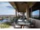 An outdoor dining area with seating overlooking a pool and mountain view at 1123 Christian Rd, Henderson, NV 89002