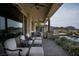 Outdoor patio with comfortable seating, lush greenery, and a beautiful view of the mountains at 1123 Christian Rd, Henderson, NV 89002