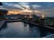 Backyard pool featuring elegant fire bowls for a nighttime ambiance at 1123 Christian Rd, Henderson, NV 89002