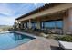 Beautiful pool area with stone patio and outdoor dining under a covered patio area at 1123 Christian Rd, Henderson, NV 89002