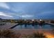 Backyard pool with fire bowls and desert landscape for an evening swim at 1123 Christian Rd, Henderson, NV 89002