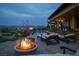 Serene poolside setting with lounge chairs, a fire feature, and mountain views beyond at 1123 Christian Rd, Henderson, NV 89002