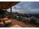 Inviting backyard pool area with a stone patio, elegant lanterns, and stunning mountain views at 1123 Christian Rd, Henderson, NV 89002