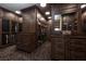 Large, custom walk-in closet with dark wood cabinets and glass doors at 1123 Christian Rd, Henderson, NV 89002
