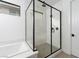 Bright bathroom with glass-enclosed shower, black hardware, and modern fixtures at 11990 Montague St, Las Vegas, NV 89138