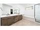 Modern bathroom with double vanity, soaking tub, and glass-enclosed shower at 11990 Montague St, Las Vegas, NV 89138