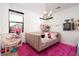 Bright bedroom with a whimsical hanging chair, pink rug, and charming decor at 11990 Montague St, Las Vegas, NV 89138