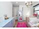 Stylized bedroom with a plush pink rug, modern light fixture and unique decor at 11990 Montague St, Las Vegas, NV 89138