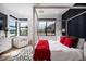 Stylish bedroom with a four-poster bed, plush bedding, and natural light at 11990 Montague St, Las Vegas, NV 89138