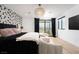 Bright bedroom featuring modern light fixture, wallpapered accent wall, and patio access at 11990 Montague St, Las Vegas, NV 89138