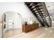 Stylish entryway with modern staircase, decorative mirror, and a chic console table creating a welcoming ambiance at 11990 Montague St, Las Vegas, NV 89138