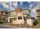 Modern two-story home with stone accents, manicured landscaping, and a private gated entrance in a desert setting at 11990 Montague St, Las Vegas, NV 89138