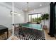 Bright game room with ping pong table, large windows, modern light fixture and stylish decor at 11990 Montague St, Las Vegas, NV 89138