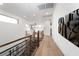 Bright hallway with sleek railings and wood floors leading to living spaces at 11990 Montague St, Las Vegas, NV 89138