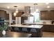 Modern kitchen with island, breakfast bar, and stainless steel appliances at 11990 Montague St, Las Vegas, NV 89138