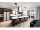 Open kitchen features a center island with seating and modern light fixtures at 11990 Montague St, Las Vegas, NV 89138
