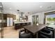 Elegant kitchen featuring an island with bar seating, stainless steel appliances, and seamless access to the outdoor pool area at 11990 Montague St, Las Vegas, NV 89138