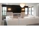 Cozy living room highlighting the fireplace, stylish light fixture, and comfortable sectional sofa, creating a relaxing space at 11990 Montague St, Las Vegas, NV 89138