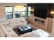 Stylish living room featuring a cozy fireplace, custom wood accent wall, and a plush, oversized sectional sofa at 11990 Montague St, Las Vegas, NV 89138