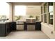 Well-equipped outdoor kitchen with built-in grill, sink, and storage for outdoor cooking at 11990 Montague St, Las Vegas, NV 89138