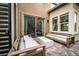 Cozy outdoor patio with comfortable seating and sliding glass doors to the home's interior at 11990 Montague St, Las Vegas, NV 89138