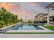 Beautiful pool with tiled accents, lush landscaping and view of the home's architecture at 11990 Montague St, Las Vegas, NV 89138