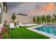 Inviting backyard with a sparkling pool, lounge chairs, and beautiful landscaping at 11990 Montague St, Las Vegas, NV 89138