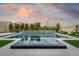 Stunning pool with integrated spa and modern black and white diamond tile accents, surrounded by lush landscaping at 11990 Montague St, Las Vegas, NV 89138