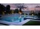 Backyard pool and spa with diamond patterned wall and lush landscaping create a backyard oasis at 11990 Montague St, Las Vegas, NV 89138