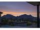A dusk view from the balcony showcasing the community and distant mountains at 11990 Montague St, Las Vegas, NV 89138