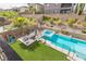 Aerial view of backyard featuring outdoor pool, jacuzzi, manicured lawn, and surrounding landscaping at 12356 Notch Trail Ave, Las Vegas, NV 89138