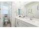 Well-lit bathroom featuring a double sink vanity, tiled floors, and a separate toilet area at 12356 Notch Trail Ave, Las Vegas, NV 89138