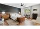 Stylish bedroom featuring a modern accent wall, wood flooring, and a bright window at 12356 Notch Trail Ave, Las Vegas, NV 89138