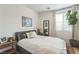 Bright bedroom with neutral walls, wood floors, and a large window that offers natural light at 12356 Notch Trail Ave, Las Vegas, NV 89138