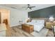 Well-lit bedroom with a dark accent wall, wood floors, and a cozy decor at 12356 Notch Trail Ave, Las Vegas, NV 89138