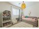 Bedroom featuring modern light fixture, window, books, and space for children to play at 12356 Notch Trail Ave, Las Vegas, NV 89138