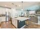 Open-concept kitchen featuring a large island with seating, stainless steel appliances, and modern finishes at 12356 Notch Trail Ave, Las Vegas, NV 89138