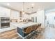Well-equipped kitchen featuring a spacious island, modern appliances, and stylish white cabinetry at 12356 Notch Trail Ave, Las Vegas, NV 89138