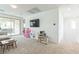 Spacious living room with neutral color scheme, carpeted floors, TV, and lots of natural light at 12356 Notch Trail Ave, Las Vegas, NV 89138