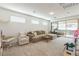 Spacious living room featuring neutral color scheme, carpet, and lots of natural light at 12356 Notch Trail Ave, Las Vegas, NV 89138