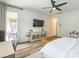 Bright main bedroom features wood floors, neutral walls, mounted TV, and sliding door to the outdoor space at 12356 Notch Trail Ave, Las Vegas, NV 89138