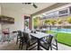 Inviting outdoor dining area with a tv and a view of the pool and backyard at 12356 Notch Trail Ave, Las Vegas, NV 89138